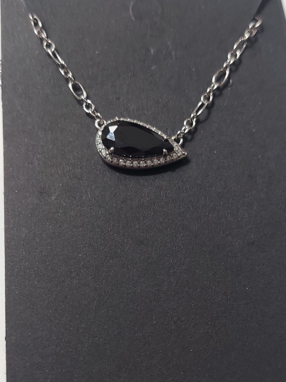Bomb Party "Where It Lands" teardrop necklace features a black stone.